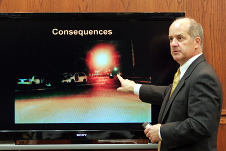 Prosecutor J. David Meyer presents photographic details of the accident scene during the opening arguments in the vehicular homicide trial of New Jersey State Trooper Robert Higbee. Higbee is accused in the deaths of Upper Township sisters Jacqueline and Christina Becker stemming from a Sept. 27, 2006 traffic accident. (AP Photo/The Press of Atlantic City, Dale Gerhard)
