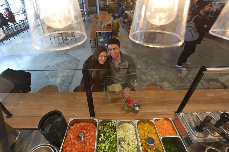 Penn seniors Lianne Menkes and Noah Klayman wait for their food at the Goldie in the new, mostly cashless Franklin’s Table at 34th and Walnut