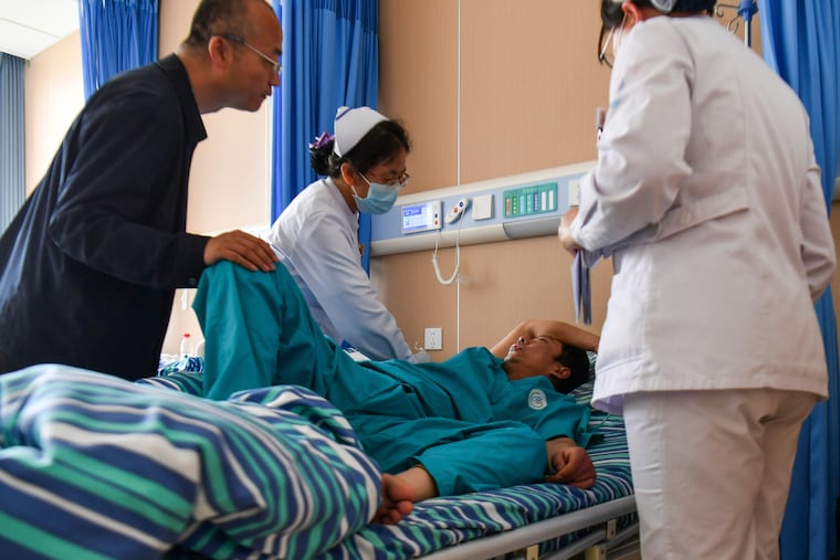 In this photo released by Xinhua News Agency, medical staff attend to an injured worker at a hospital in the aftermath of an explosion at Changzhi city's Liushenyu coal mine in Qinyuan county, northern China's Shanxi Province on Saturday, May 23, 2026.