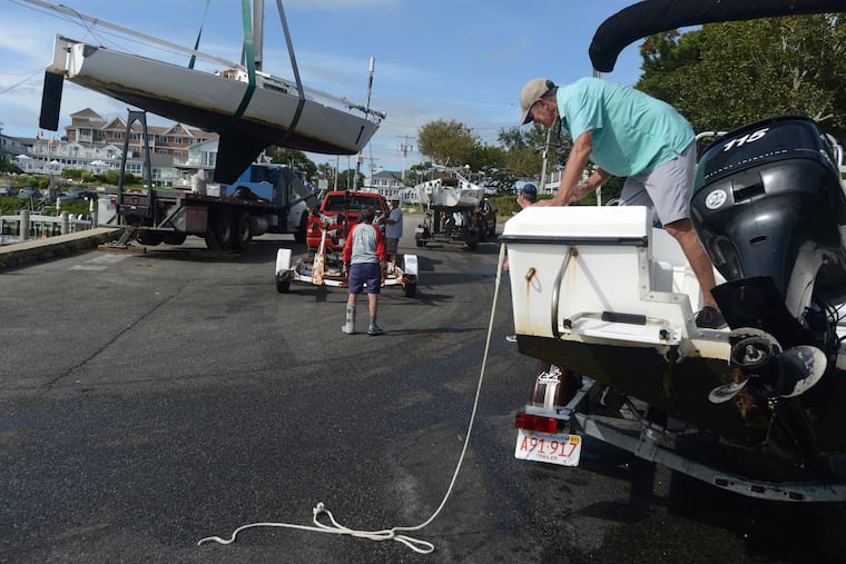 Baxter Crane Company hauls a yacht onto a trailer in Hyannis. Mass., in preparation for a visit from Henri.