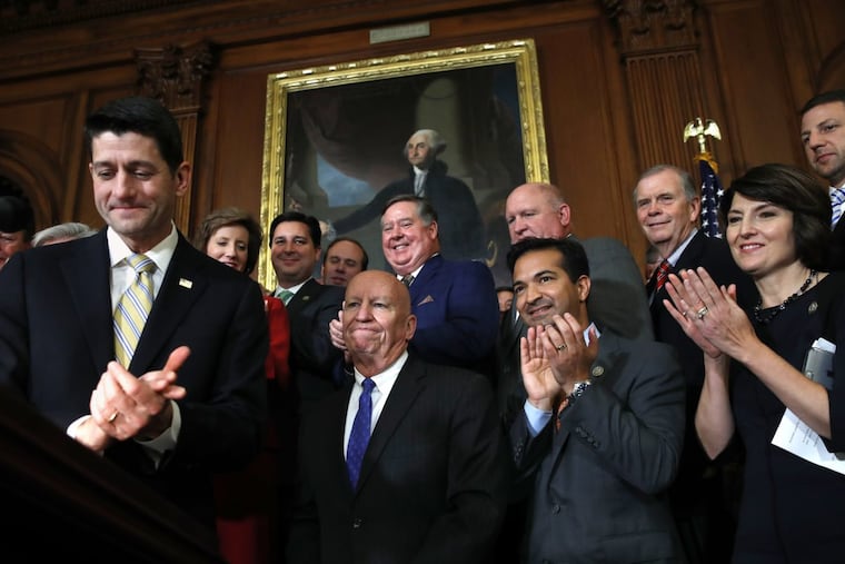 House Speaker Paul Ryan, left, leads fellow Republicans in applauding their tax reform bill.