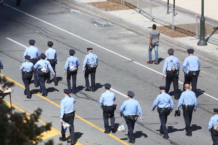 Philadelphia police walk the Benjamin Franklin Parkway in advance of Pope Francis' visit. The police were part of a security effort that also included the FBI and other federal investigative and law-enforcement agencies.