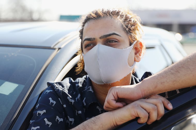 Usman Razak next to his car in Southwest Philadelphia. Razak is an Uber driver who no longer drives for the company full-time because he is immunocompromised and worried about exposure to the coronavirus.