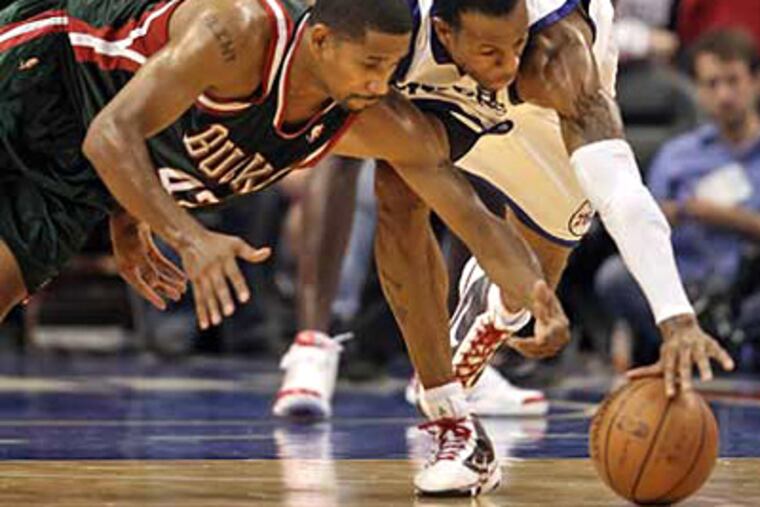 Andre Iguodala takes the ball from the Bucks' Charlie Bell during the fourth quarter of the Sixers' 99-86 win over Milwaukee yesterday. (Steven M. Falk / Staff Photographer)