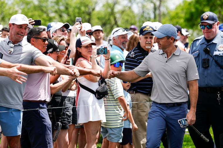 Rory McIlroy greets fans during the first round of the Truist Championship at the Philadelphia Cricket Club on Thursday.