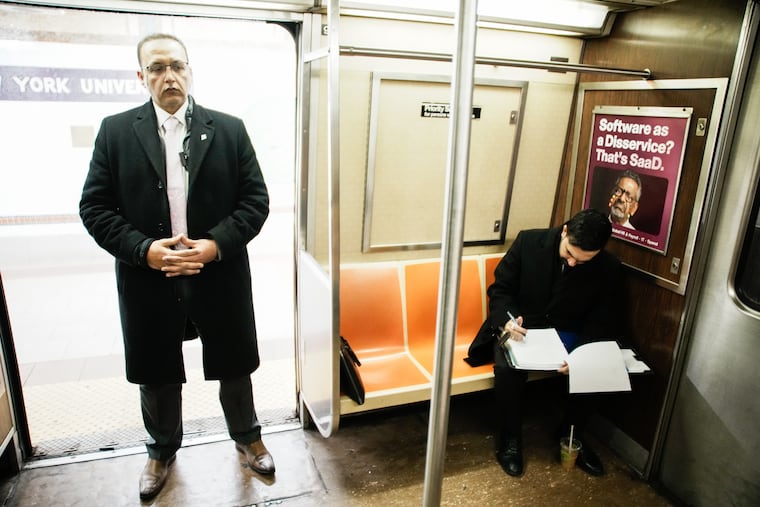 New York City Mayor Zohran Mamdani checks his agenda Friday on the subway on his way to City Hall.
