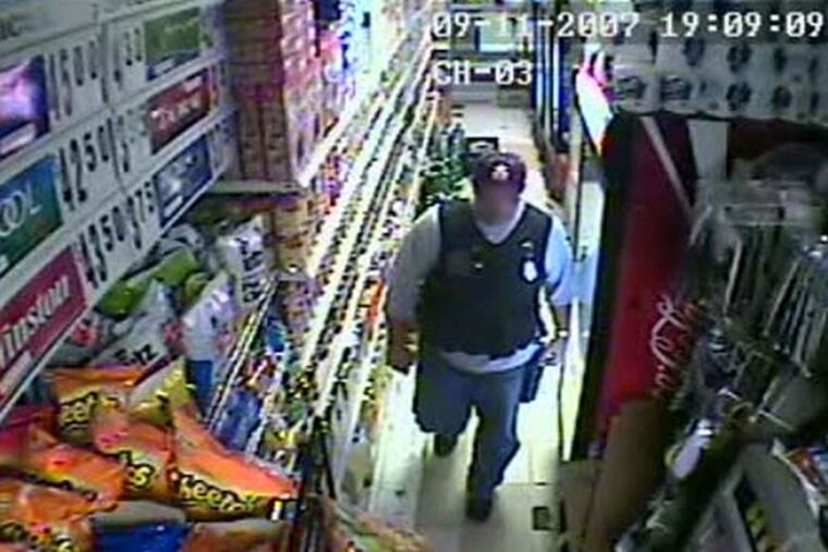 Surveillance video still of then Philadelphia Police Sergeant Joseph Bologna, now a lieutenant, during a raid of a West Oak Lane grocery store on September 11, 2007.