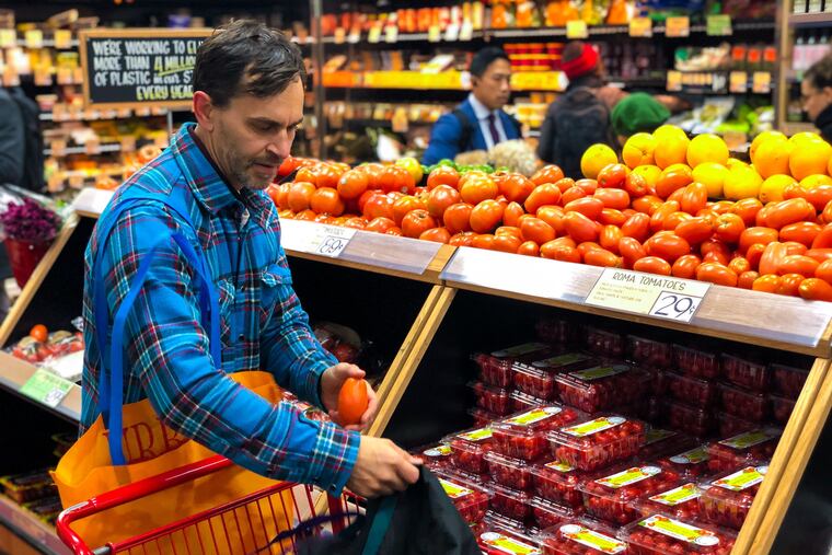 Logan Welde, director of legislative affairs at Clean Air Council, fills his reusable bags on a recent grocery store trip.