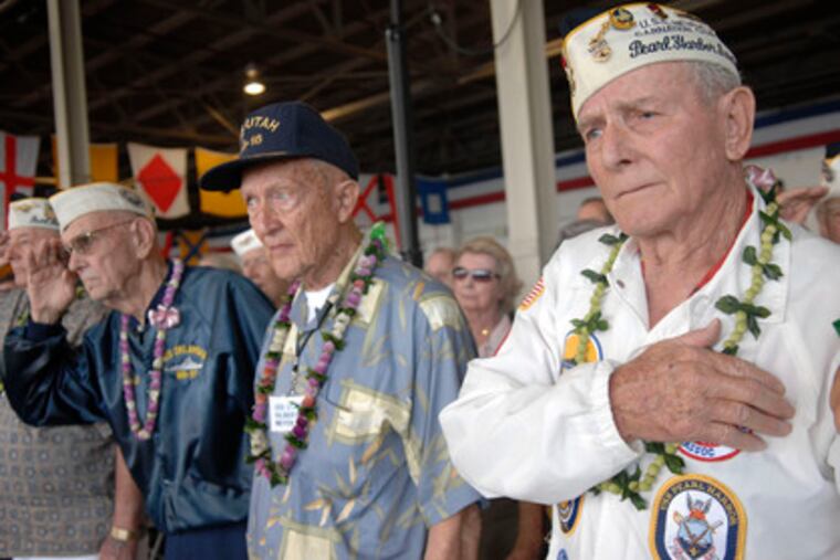 World War II veterans participate in a Pearl Harbor commemoration yesterday at Pearl Harbor, Hawaii, joining other vets in observing the 67th anniversary of the devastating Japanese military raid. Story, Page 12.