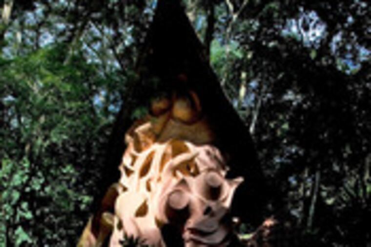 A boy walks by a shrine in Osogbo. Thieves and zealous Christians have been accused of looting ancient symbols.