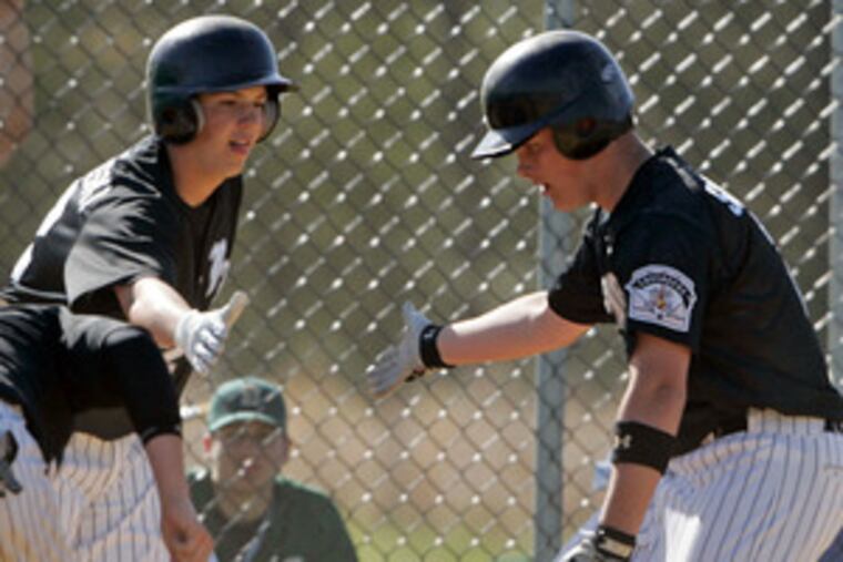 Eustace's Dan Sieracki (right) shares some skin with Greg Brodzinski after hitting a three-run homer off starting pitcher Dan Grovah. The Crusaders have a two-game cushion atop the National Division.