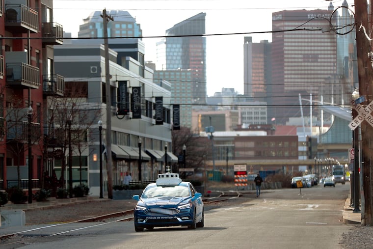 One of the test vehicles from Argo AI, Ford's autonomous vehicle unit, navigates through the strip district near the company offices in Pittsburgh. Argo AL has been among the busiest testers of self-driving vehicles in Pennsylvania.