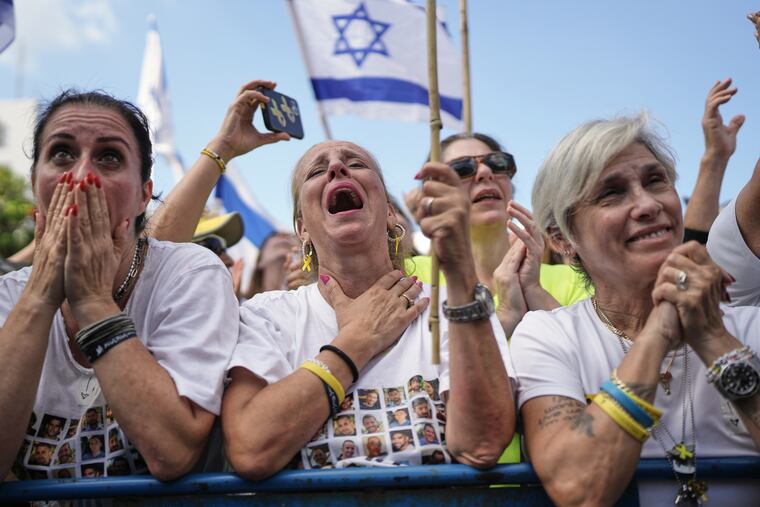 People react as they gather to watch a live broadcast of Israeli hostages being released from Gaza at a plaza known as hostages square in Tel Aviv, Israel, on Monday, Oct. 13.