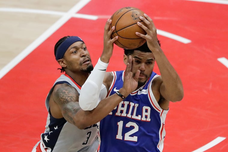 Sixers forward Tobias Harris catches the basketball as Washington Wizards guard Bradley Beal attempts to defend him. Beal is in the process of being traded to the Phoenix Suns.