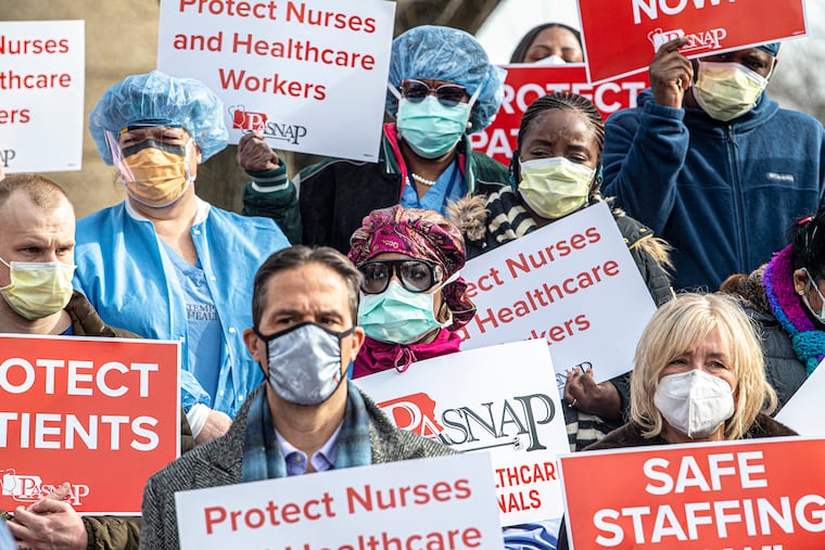 Nurses protest during a rally on Thursday, January 13, 2022., at the Temple University Hospital in Philadelphia, Pa. Nurses and technical professionals from Temple University Hospital, main and Jeanes campus, join members of National Nurses United across the country to hold a public action on Thursday, January 13 to demand the hospital industry invest in safe staffing and provide frontline healthcare professionalsÐand therefore patientsÐwith optimal protections