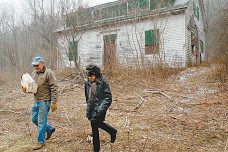 At her ancestral farm in Susquehanna County, settled in 1793, Denise Dennis strolls with caretaker John Arnone. Drillers have offered more than $800,000 for access to the Marcellus Shale. (TOM GRALISH / Staff Photographer)