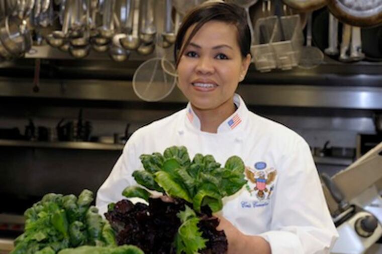 White House chef Cristeta Comerford holds winter greens in the kitchen of the White House in Washington, Tuesday, Jan. 31, 2012. The White House has fully embraced one of eating's hottest trends, seasonal cooking based on home gardening. Comerford credits the change in the food coming from the White House’s kitchen to first lady Michelle Obama’s decision in 2009 to start a garden on the South Lawn. Comerford says the garden has also helped her in her own home, where she planted a plot and she and her 10 year-old daughter cook together. (AP Photo/Susan Walsh)