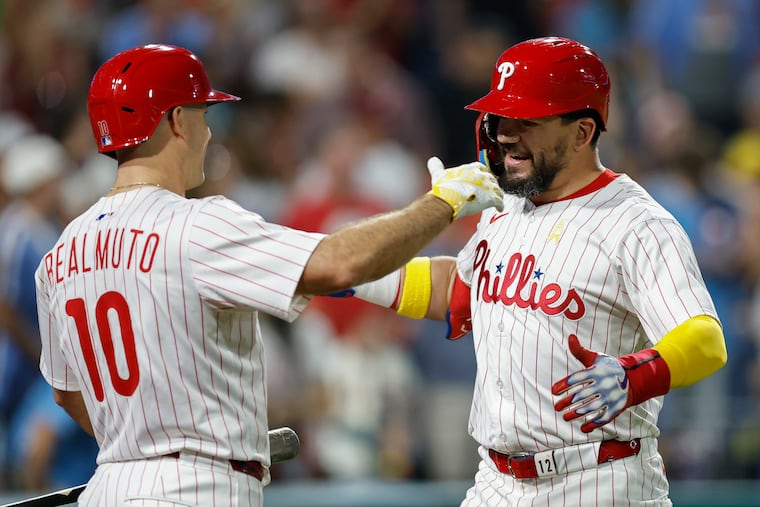 Most expect free agents J.T. Realmuto, left, and Kyle Schwarber to find their way back to the Phillies this offseason.