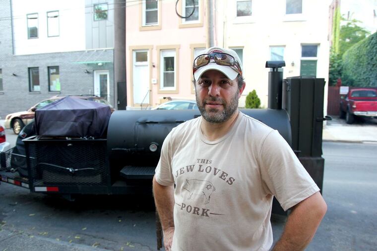 Michael Strauss of Mike’s BBQ at his smoker outside El Bar on July 7.