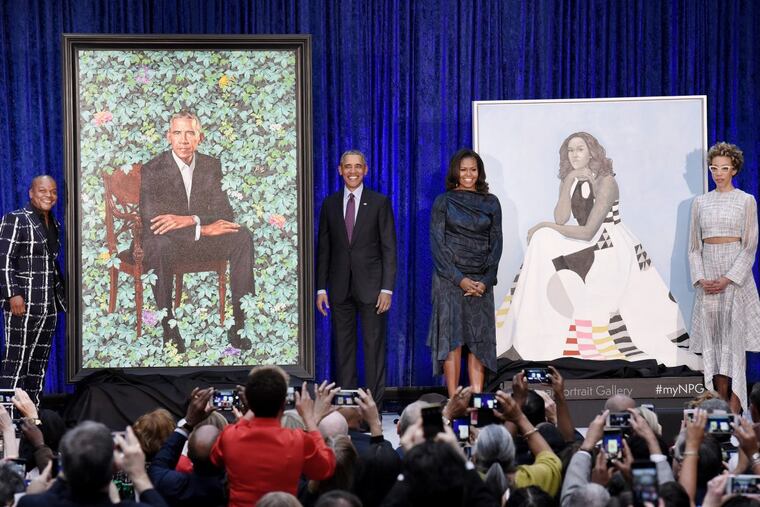 Former first lady Michelle Obama and former President Barack Obama pose with artists Kehinde Wiley and Amy Sherald during the unveiling of their official portraits at the National Portrait Gallery on Monday, February 12, 2018, in Washington, D.C.