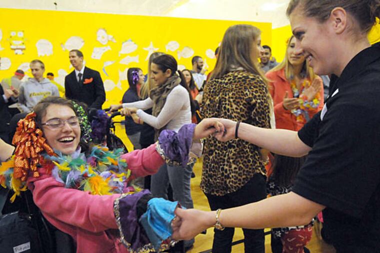 Kingsway student Alex Kelokates (left) dances with Rowan undergraduate Courtney West during a performance based on the children's book "Big Al." It was the finale of a semester-long program. APRIL SAUL / Staff Photographer