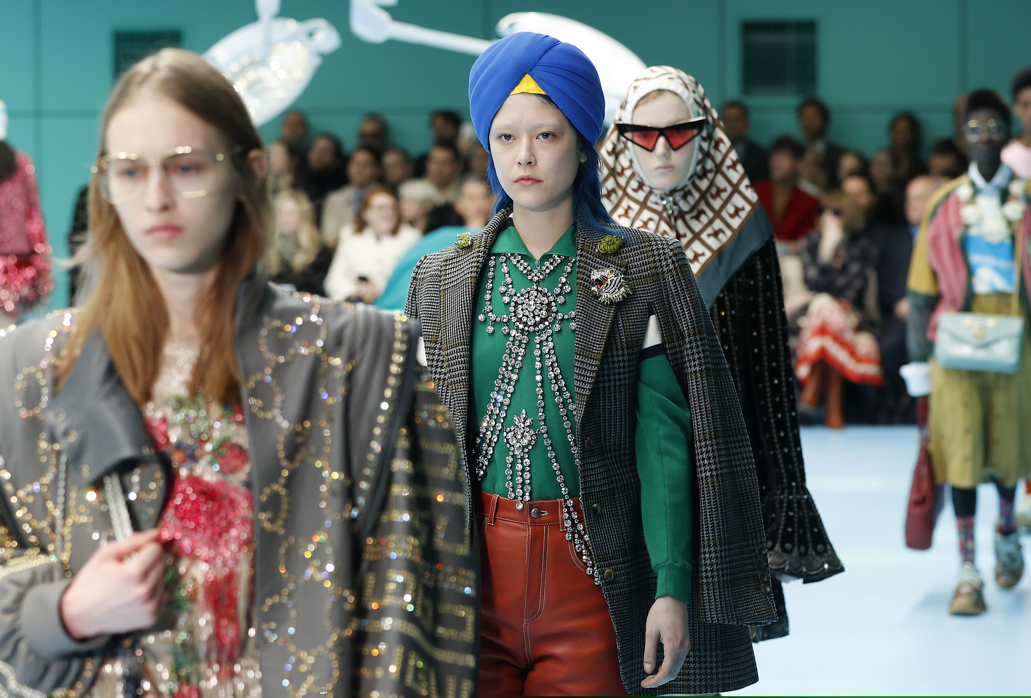 FILE - In this Feb. 21, 2018 file photo, models display items from Gucci's women's Fall/Winter 2018-2019 collection, presented during the Milan Fashion Week, in Milan, Italy. The top civil rights organization for Sikhs in the United States says Nordstrom has apologized to the community for selling an $800 turban they found offensive, but they are still waiting to hear from the Gucci brand that designed it, Saturday, May 18, 2019.