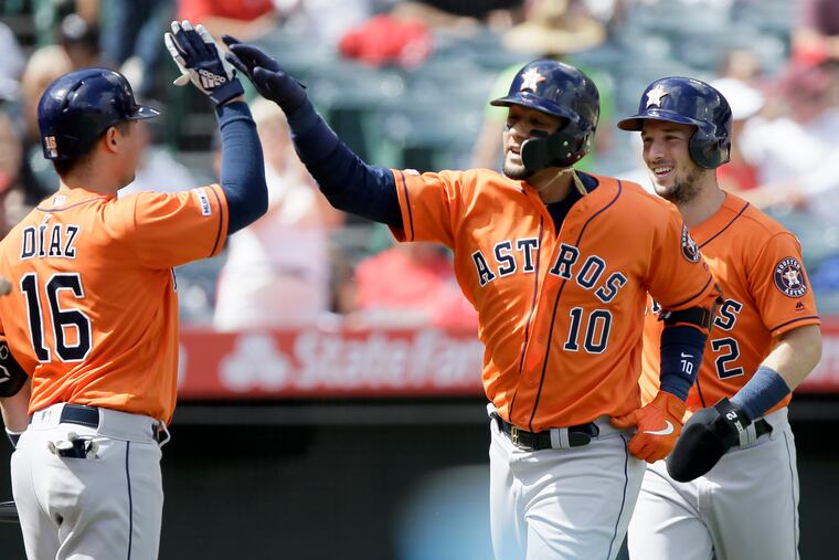 Houston's Yuli Gurriel gets congratulations from Aledmys Diaz, left, after homering in September. The Astros are favored to win the World Series at a shade over 2-1.