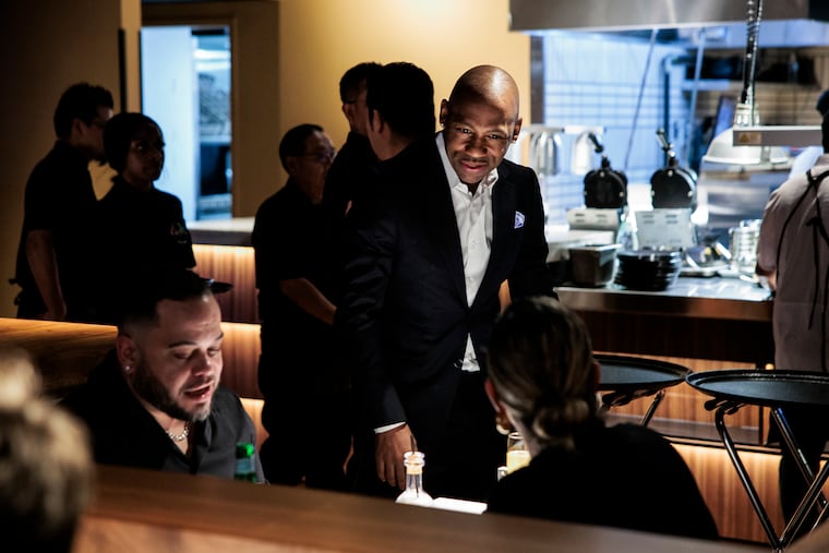 Owner Kevin Kelley greets diners during a preview dinner at his Kitchen & Kocktails restaurant.