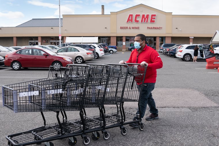 Marcus Nay collects carts in the parking lot of the ACME in South Philadelphia, April 3, 2020.