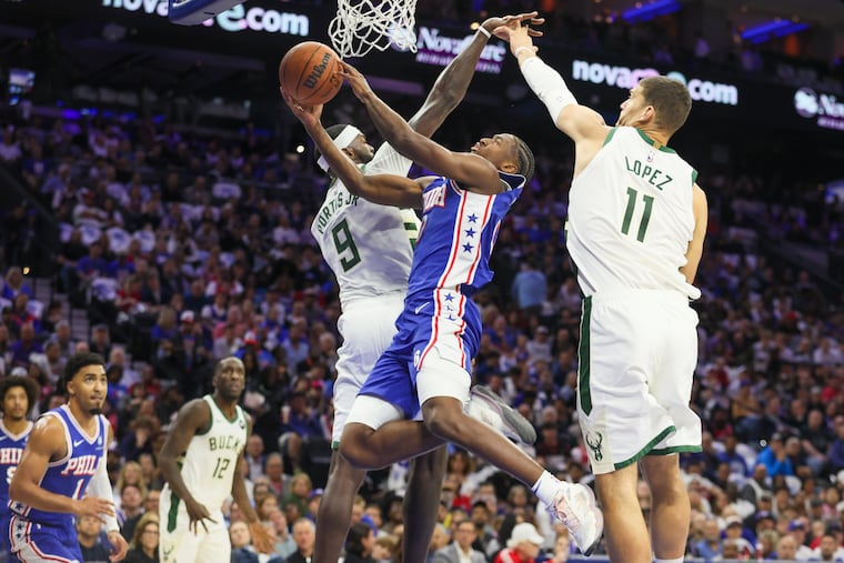 Sixers guard Tyrese Maxey goes between Milwaukee Bucks forward Bobby Portis and Brook Lopez on Wednesday, Oct. 23, 2024, in Philadelphia.