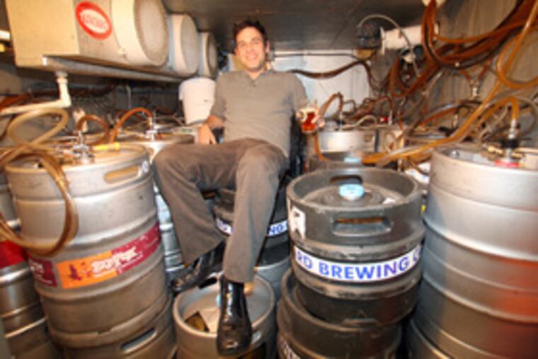 Standard Tap's bar manager Ron Johnson sits in the pub's refrigerated keg room.