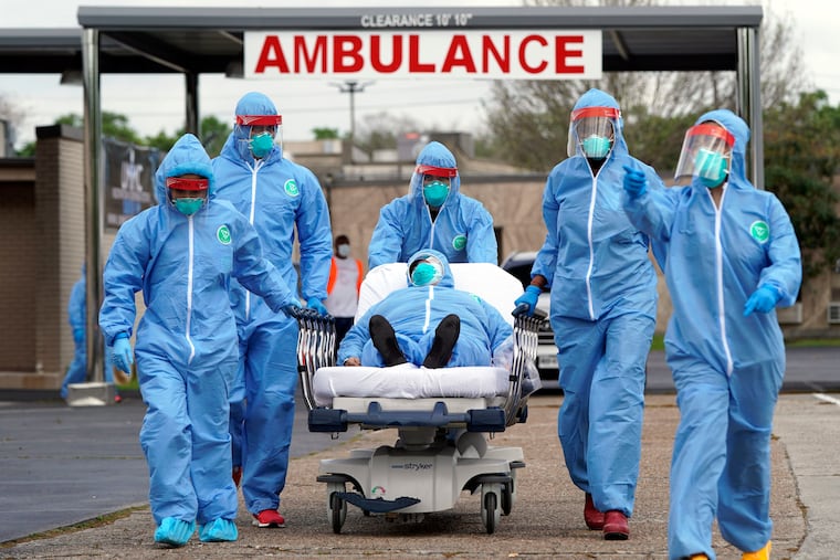 A person is taken on a stretcher into the United Memorial Medical Center after going through testing for COVID-19.