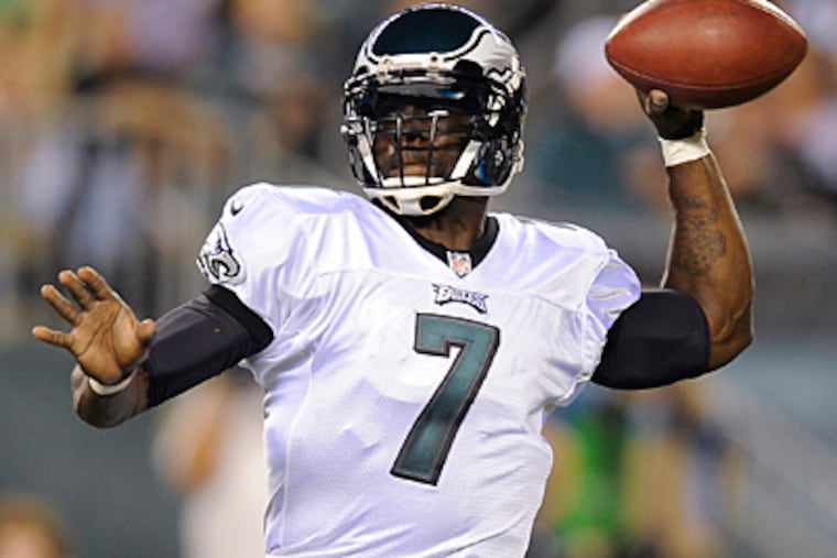 Eagles quarterback Michael Vick will wear a flack jacket in the season opener to protect his ribs. (Michael Perez/AP file photo)