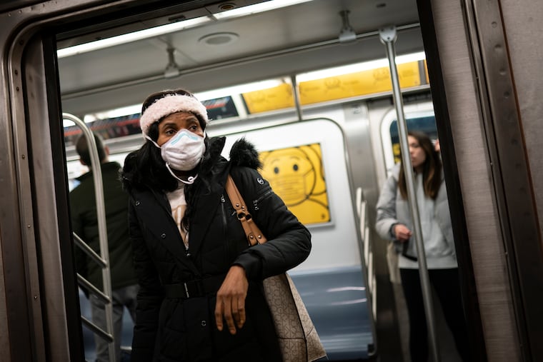 Mass transit riders wear masks as they commute in the financial district of lower Manhattan, Tuesday, April 19, 2022, in New York. U.S. District Judge Kathryn Kimball Mizelle in Tampa, Fla., on April 18, 2022, voided the national travel mask mandate as exceeding the authority of U.S. health officials. The mask mandate that covers travel on airplanes and other public transportation was recently extended by President Joe Biden's administration until May 3. (AP Photo/John Minchillo)