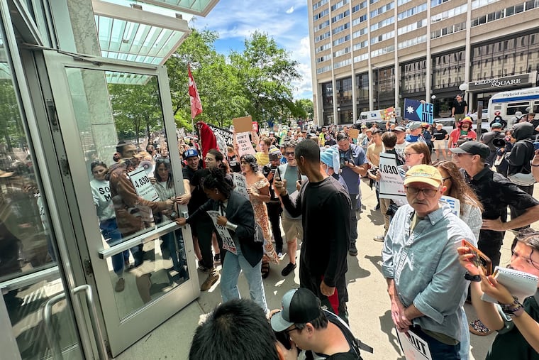 Protesters stand outside federal court in St. Louis, Minn., on Tuesday.