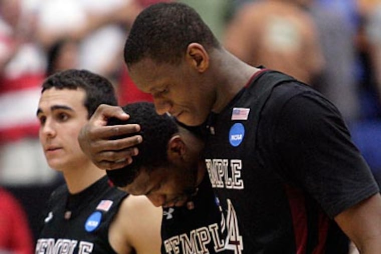 Lavoy Allen, Ramone Moore and T.J. DiLeo walk off the court after falling in double-overtime. (Yong Kim/Staff Photographer)