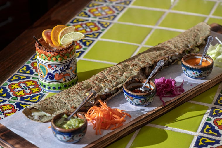 El Machete, a long quesadilla stuffed with al pastor negro, is served at Cantina La Martina, a new restaurant at D Street and Kensington Avenue in Philadelphia.