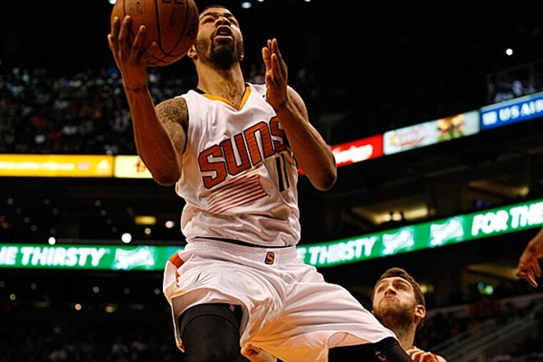 Suns power forward Markieff Morris drives and scores on 76ers center Spencer Hawes. (Rick Scuteri/AP)