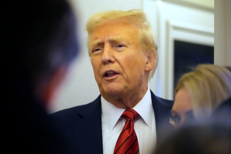 President Donald Trump speaks to reporters aboard Air Force One on Monday, Jan. 27, 2025.