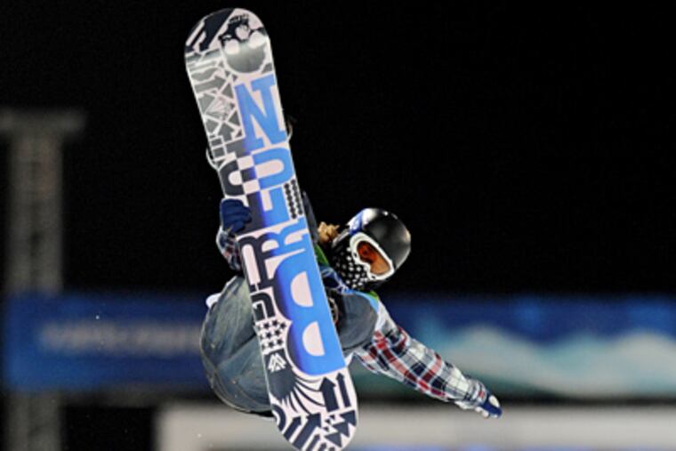 Shaun White performs a manuever during the men's snowboard halfpipe competition yesterday. (Clem Murray / Staff Photographer)