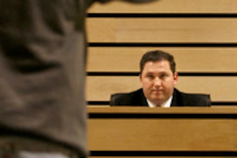 Mayor Patrick Delany, listening to an audience member during the budget meeting, says his options are limited.