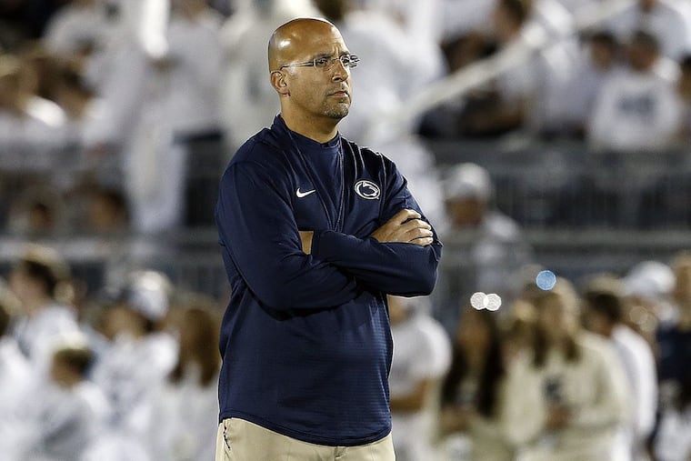 Penn State head coach James Franklin, stands on the field and watches Michigan during pre-game warm ups, before an NCAA college football game in State College, Pa., Saturday, Oct. 21, 2017.