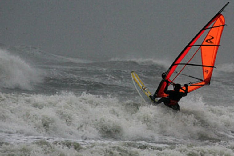 A lone windsurfer took advantage of rough seas yesterday at Strathmere, just north of Sea Isle City, one of the towns hit worse by today's continuing storm. (Akira Suwa / Staff Photographer )