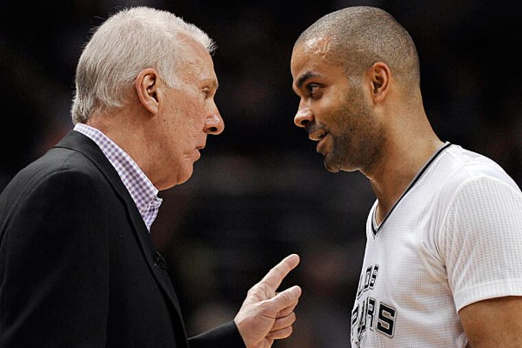 Spurs coach Gregg Popovich, left, talks to guard Tony Parker, of France, during the second half of an NBA basketball game against the Miami Heat on Thursday, March 6, 2014, in San Antonio. San Antonio won 111-87. (Darren Abate/AP)