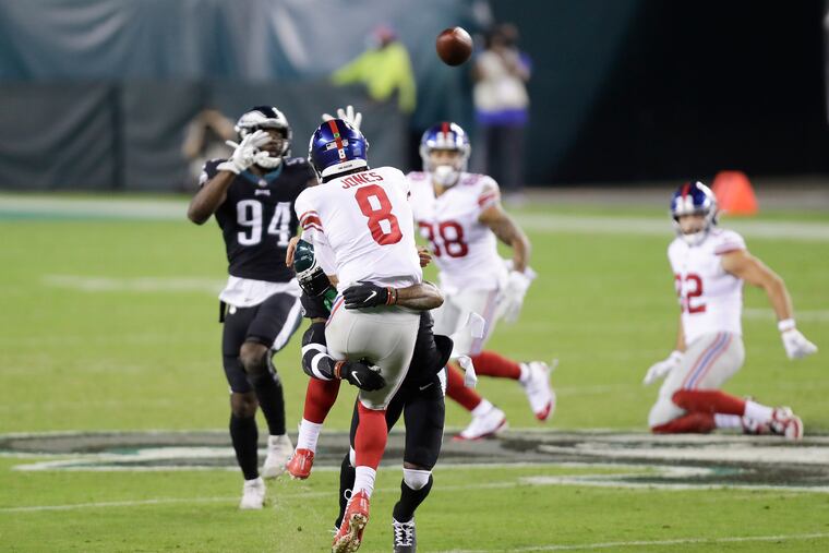 Jalen Mills, blitzing, hits Giants quarterback Daniel Jones as Jones releases a pass last Thursday.