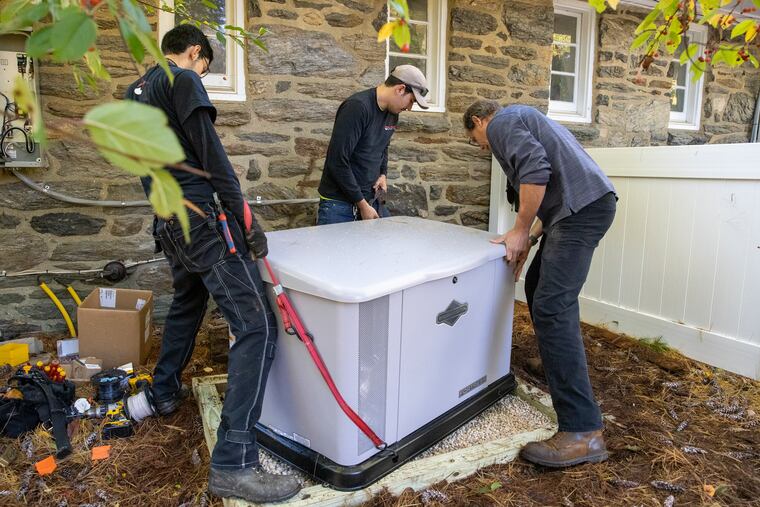 A crew from All Phase Electric Co. in Upper Darby installs a 20 kilowatt Briggs & Stratton standby generator at a home in Upper Providence, seven months after it was ordered by the homeowner. Demand for generators has soared as more people work from home. The crew, from left, are Ryan Ballinger, Bryan Callaghan and John Phillips.