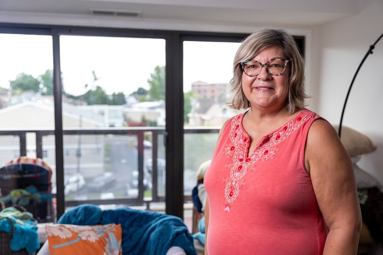 JoAnne Kim poses for a portrait in her new Ardmore apartment that she found with the help of ChatGPT.