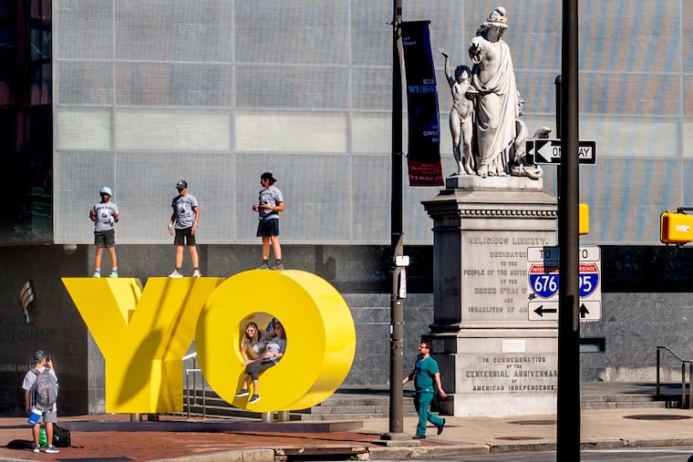 June 6, 2022: Eighth graders on their class trip from Hillwood Middle School in Fort Worth, Texas, climb on top of the "OY/YO" sculpture by artist Deborah Kass outside the Weitzman National Museum of American Jewish History on Independence Mall. At right is the 1876 sculpture "Religious Liberty," by Moses Jacob Ezekiel. The OY/YO sculpture was just installed May 1.