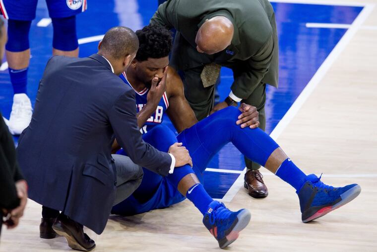 Joel Embiid getting tended to after being injured in Wednesday night’s game against the Knicks.