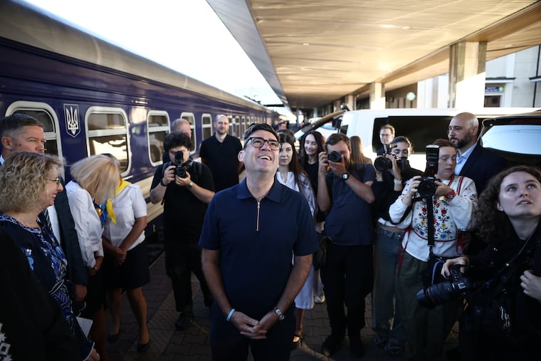 Britain's prime minister Andy Burnham, center, smiles upon his arrival by train, in Kyiv, Monday, Aug. 24, 2026.